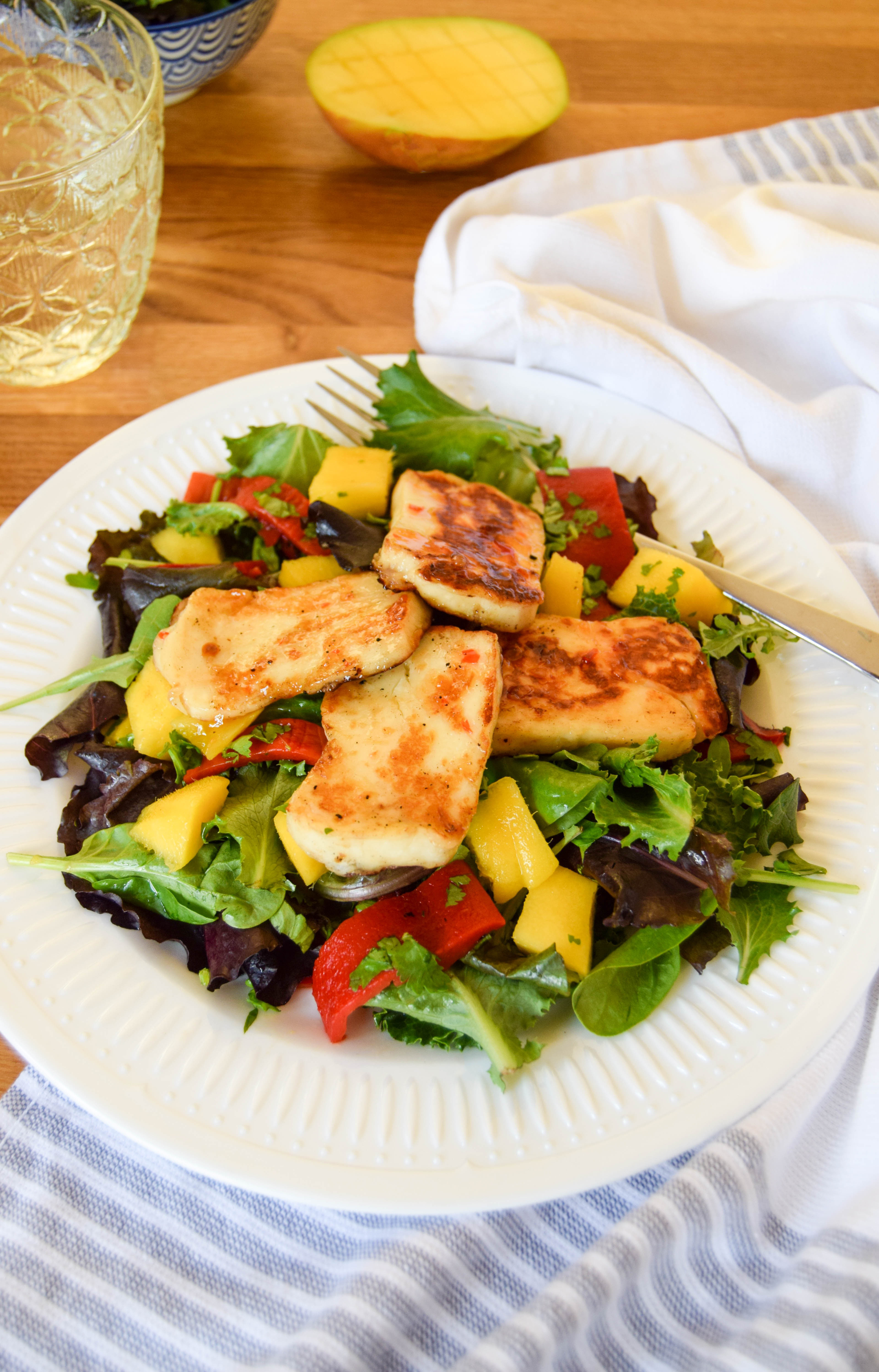 A simple salad that is quick to make and super delicious! The halloumi cheese is brushed with a sweet chilli sauce which sits so well with its natural saltiness. The fresh vibrant mango adding a summery zing.