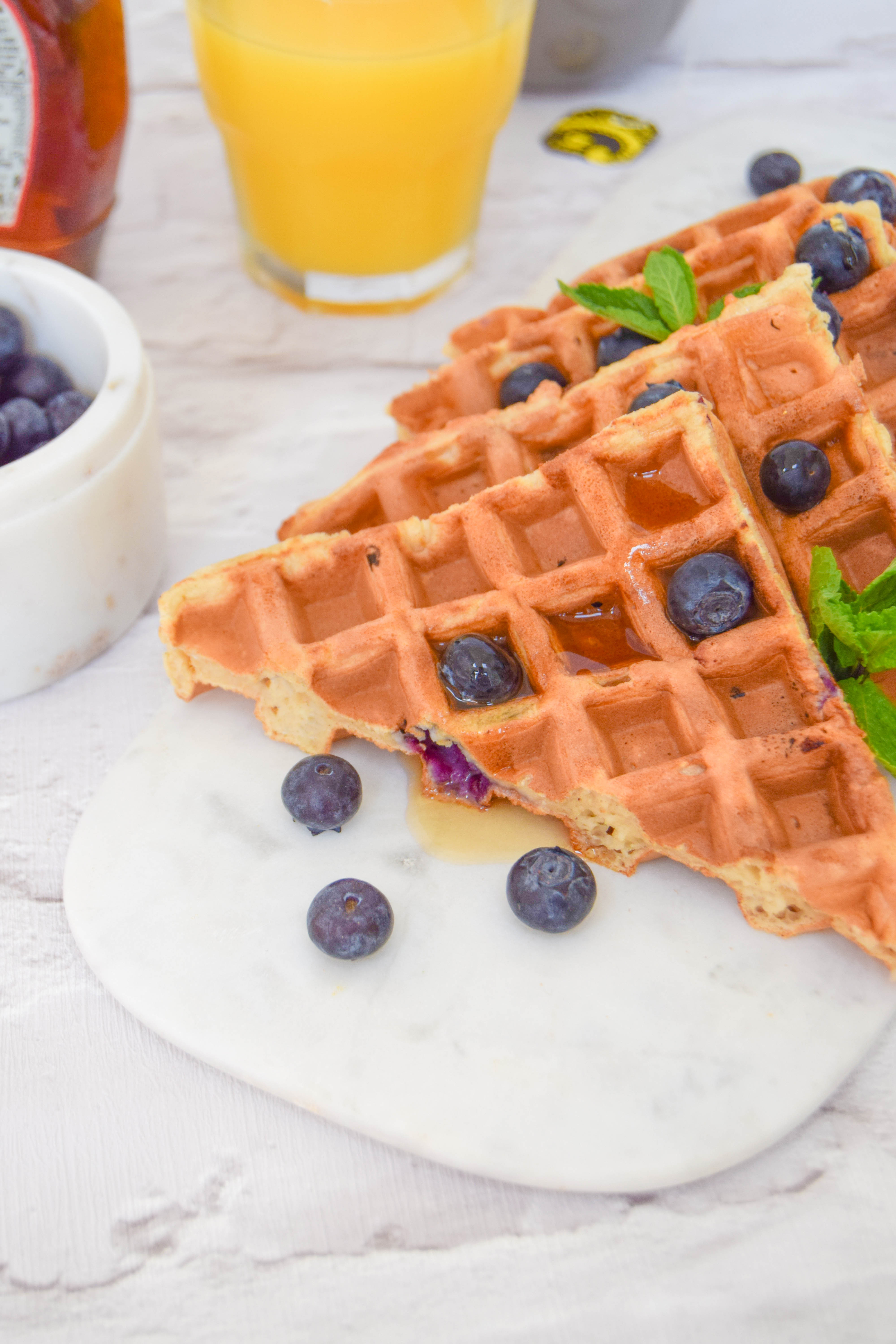 Fluffy waffles bursting with juicy blueberries for the ultimate weekend brunch. Fluffy waffles bursting with juicy blueberries for the ultimate weekend brunch.