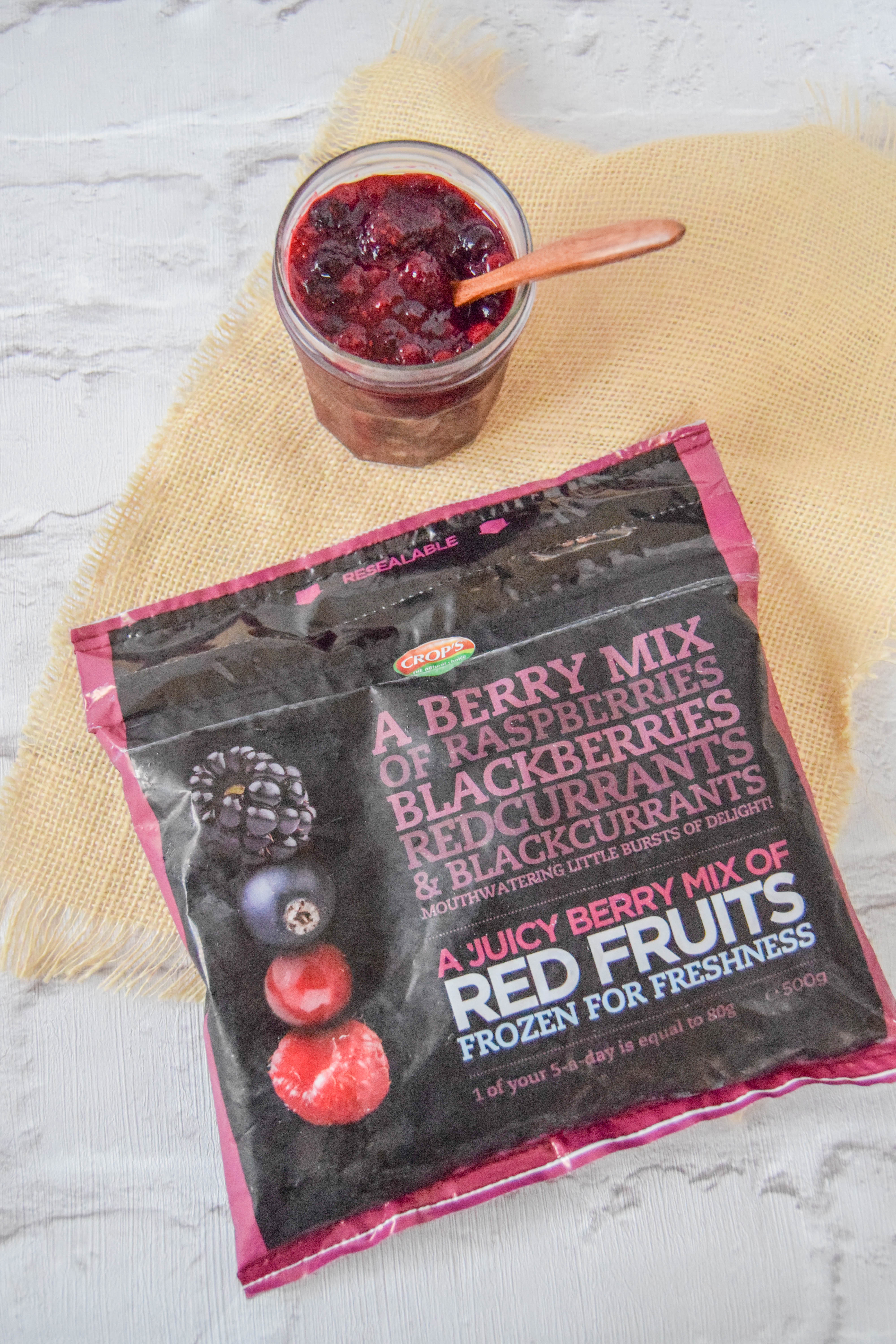 A delicious creamy coconut porridge breakfast bowl topped with a juicy homemade chia berry compote.