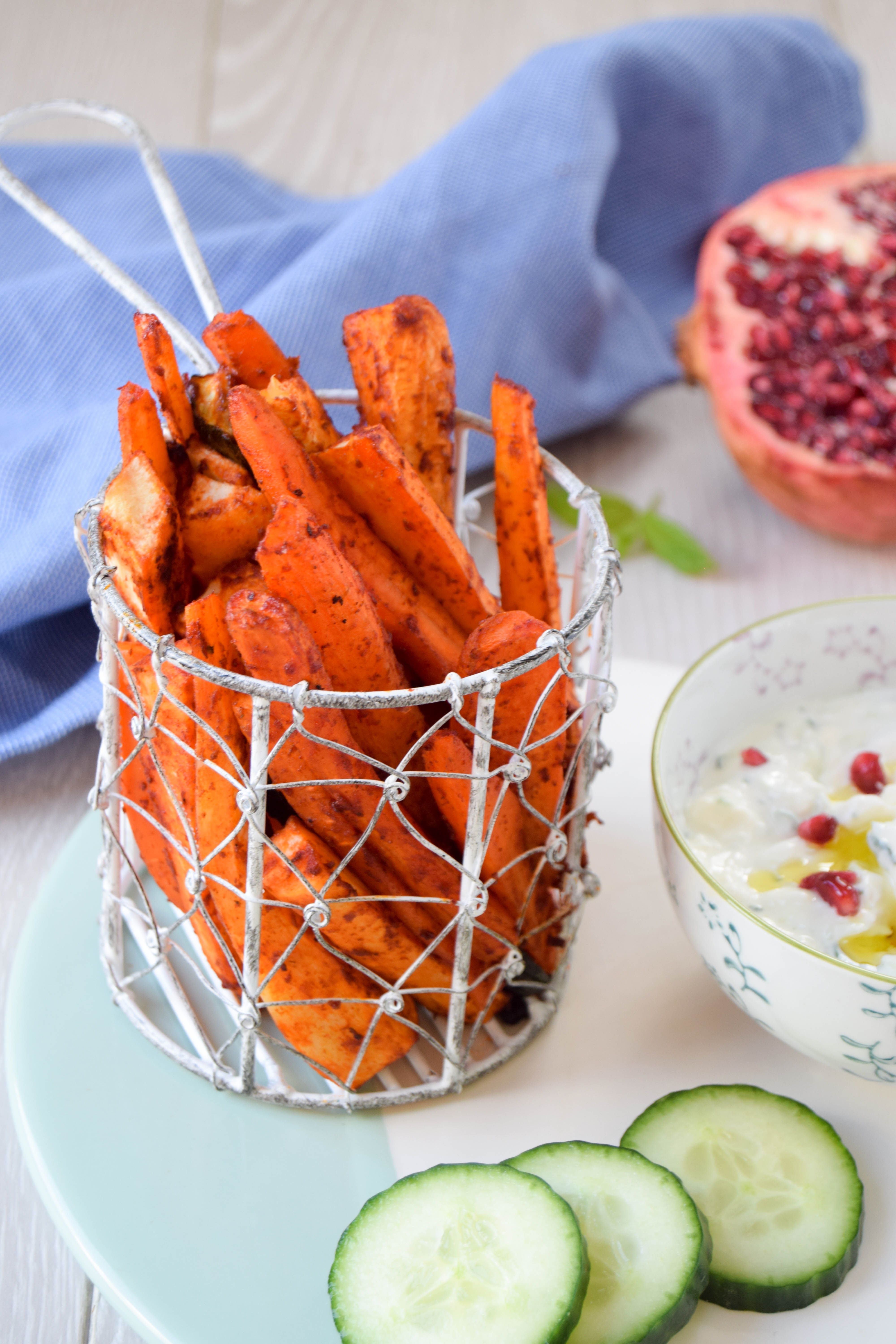 Vegetable chips coated with harissa and served with a cooling homemade feta and cucumber dip made using quark are super addictive and couldn't be easier to make than regular oven chips.
