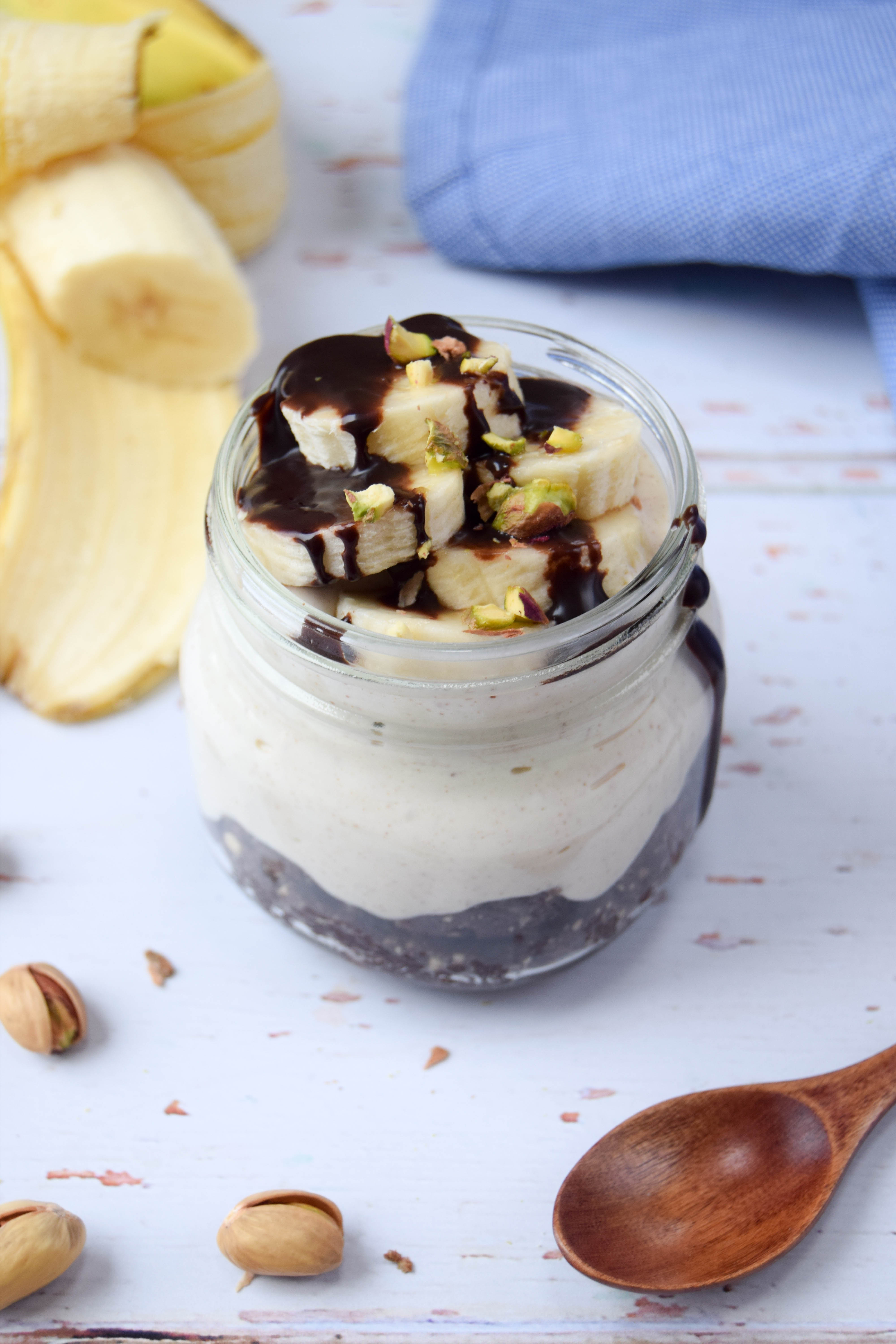 A healthier parfait dessert, made with a chocolate cookie base, creamy peanut butter filling and topped with chopped banana.