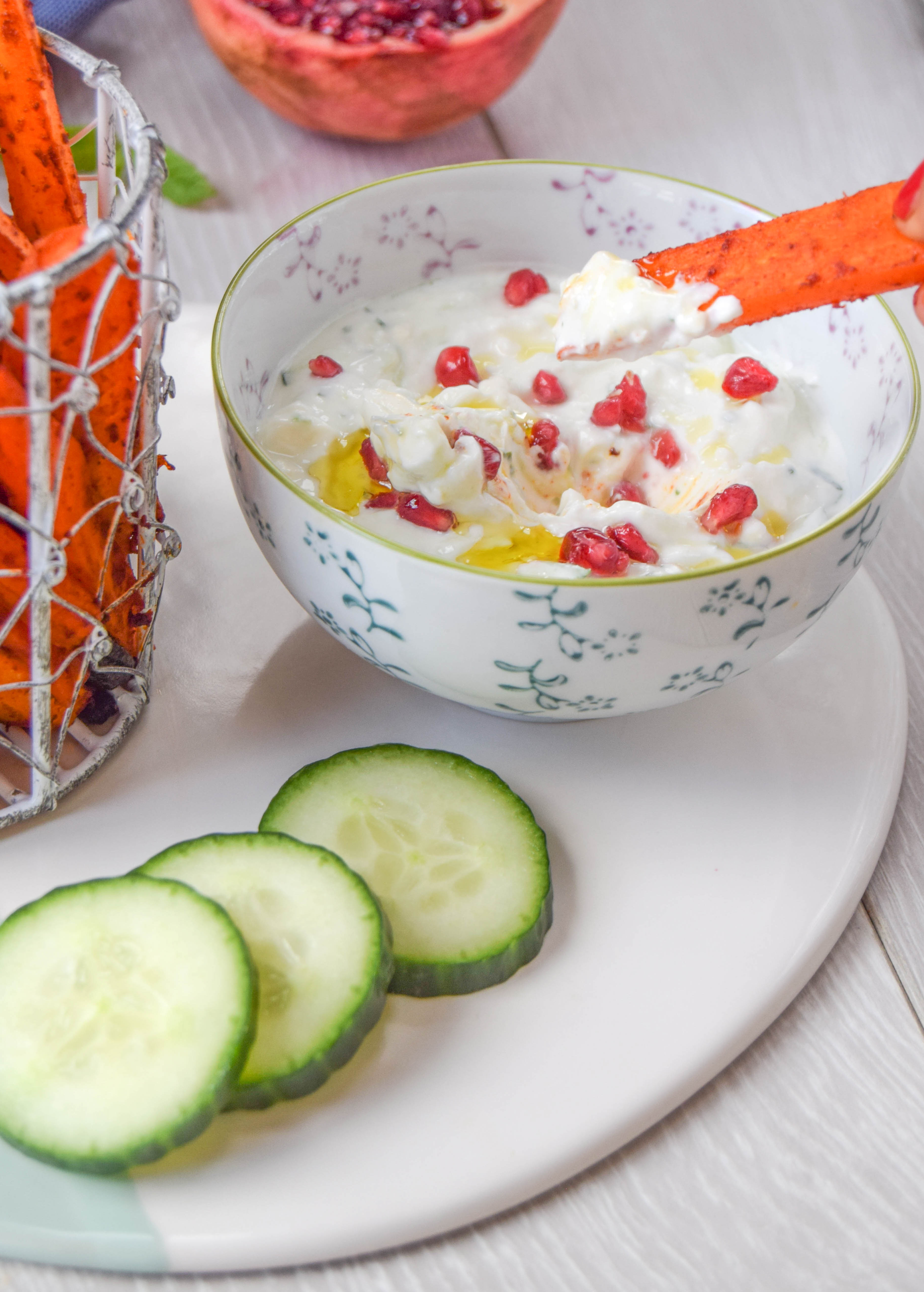 Vegetable chips coated with harissa and served with a cooling homemade feta and cucumber dip made using quark are super addictive and couldn't be easier to make than regular oven chips.