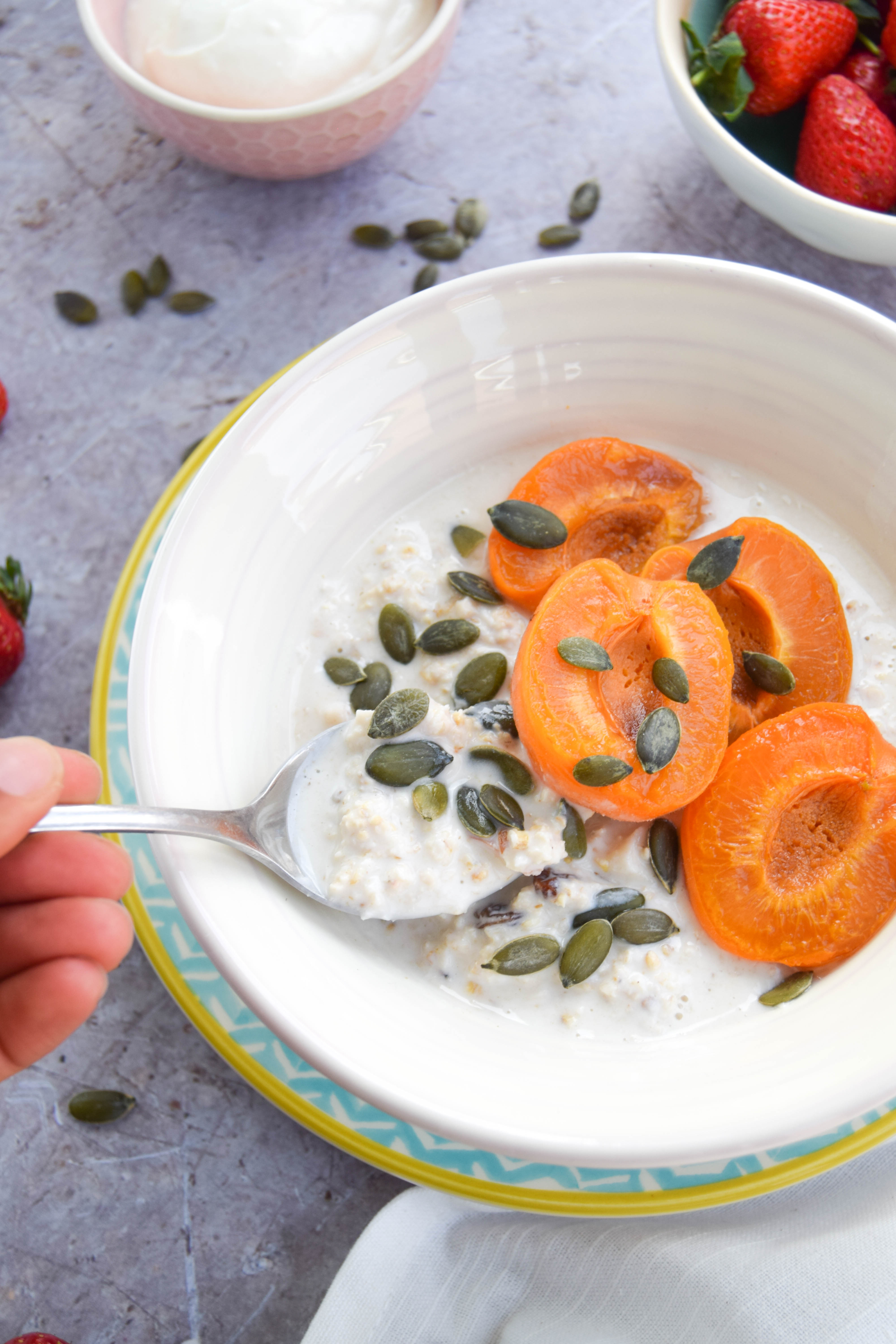 A creamy and cool bircher muesli recipe made with almonds and coconut and topped with sweet and sticky maple apricots. The perfect summer breakfast!