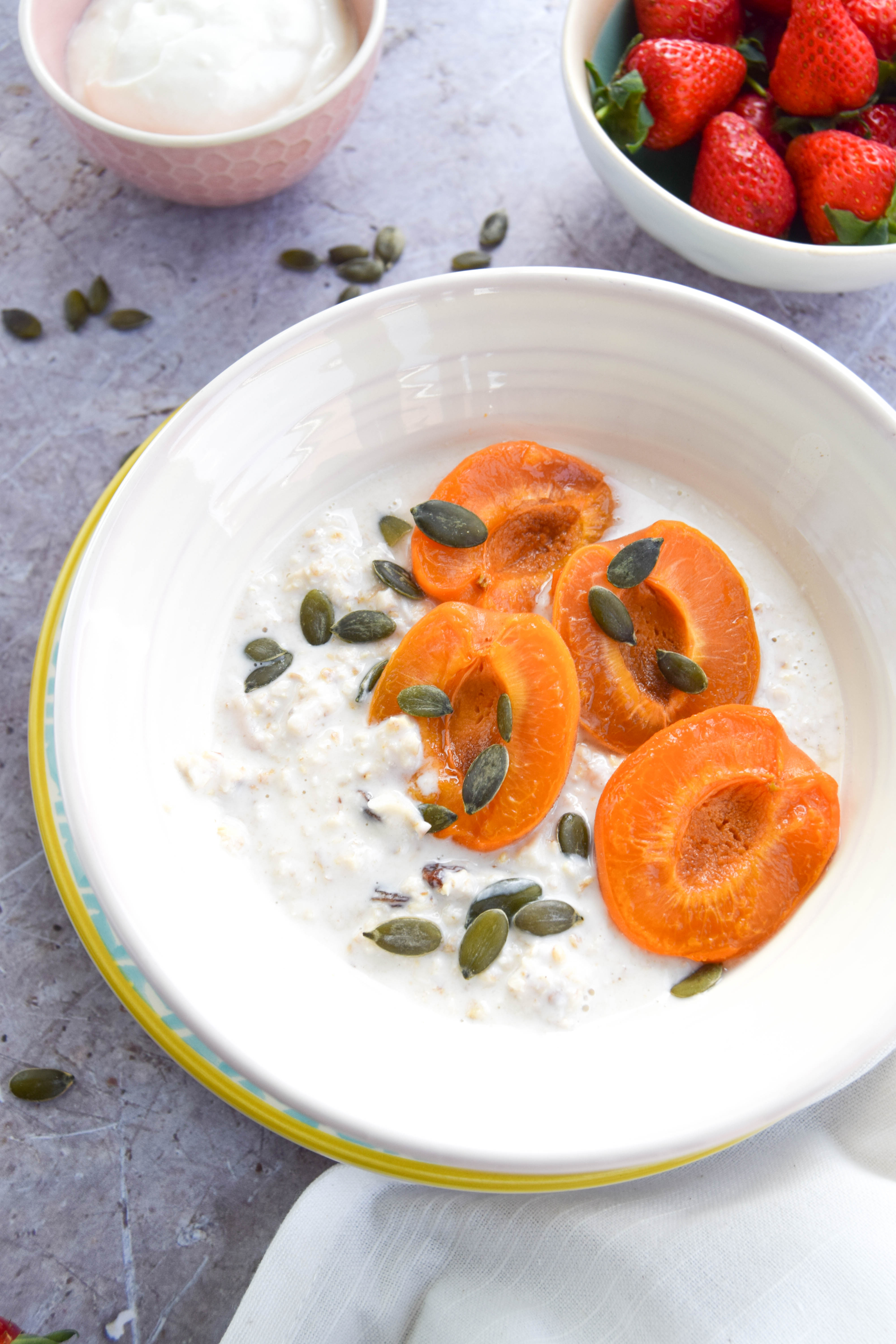 A creamy and cool bircher muesli recipe made with almonds and coconut and topped with sweet and sticky maple apricots. The perfect summer breakfast!