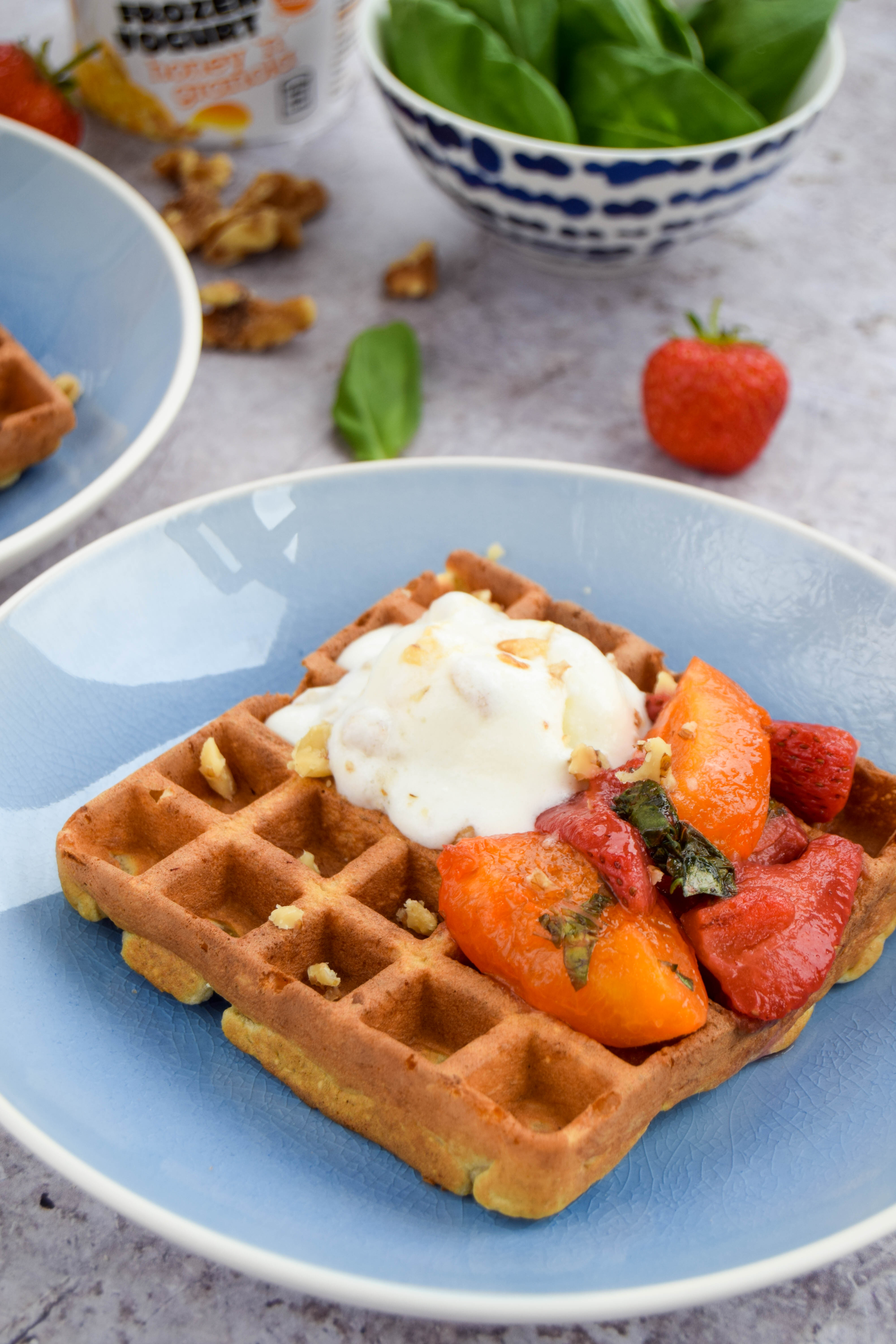Enjoy fresh fruit to start your day? Catch up with friends with these oat waffles topped with an apricot sauce made with softened apricots, strawberries, and basil.