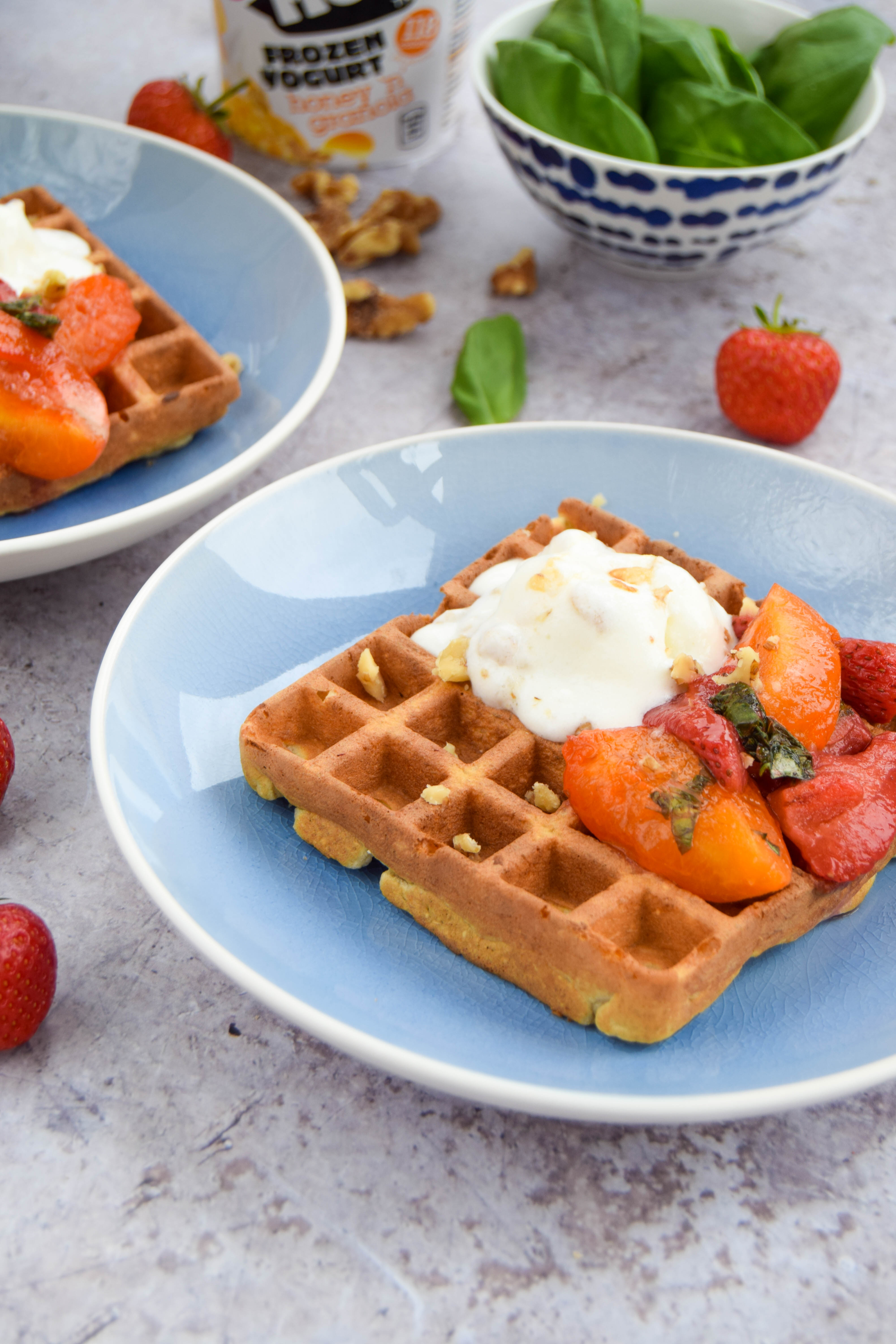 Enjoy fresh fruit to start your day? Catch up with friends with these oat waffles topped with an apricot sauce made with softened apricots, strawberries, and basil.