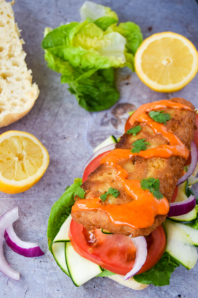 Quick and simple, but doesn't compromise on taste. Speedy comfort food in the form of a chip shop fish sandwich drizzled with sriracha mayonnaise. Quick and simple, but doesn't compromise on taste. Speedy comfort food in the form of a chip shop fish sandwich drizzled with sriracha mayonnaise.