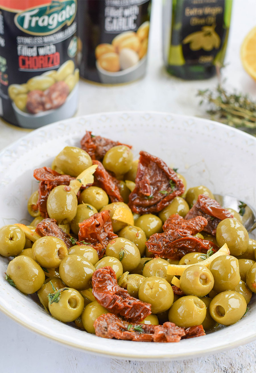 Delicious green Manzanilla olives filled with chorizo and garlic marinated with lemon, thyme, and sundried tomatoes.