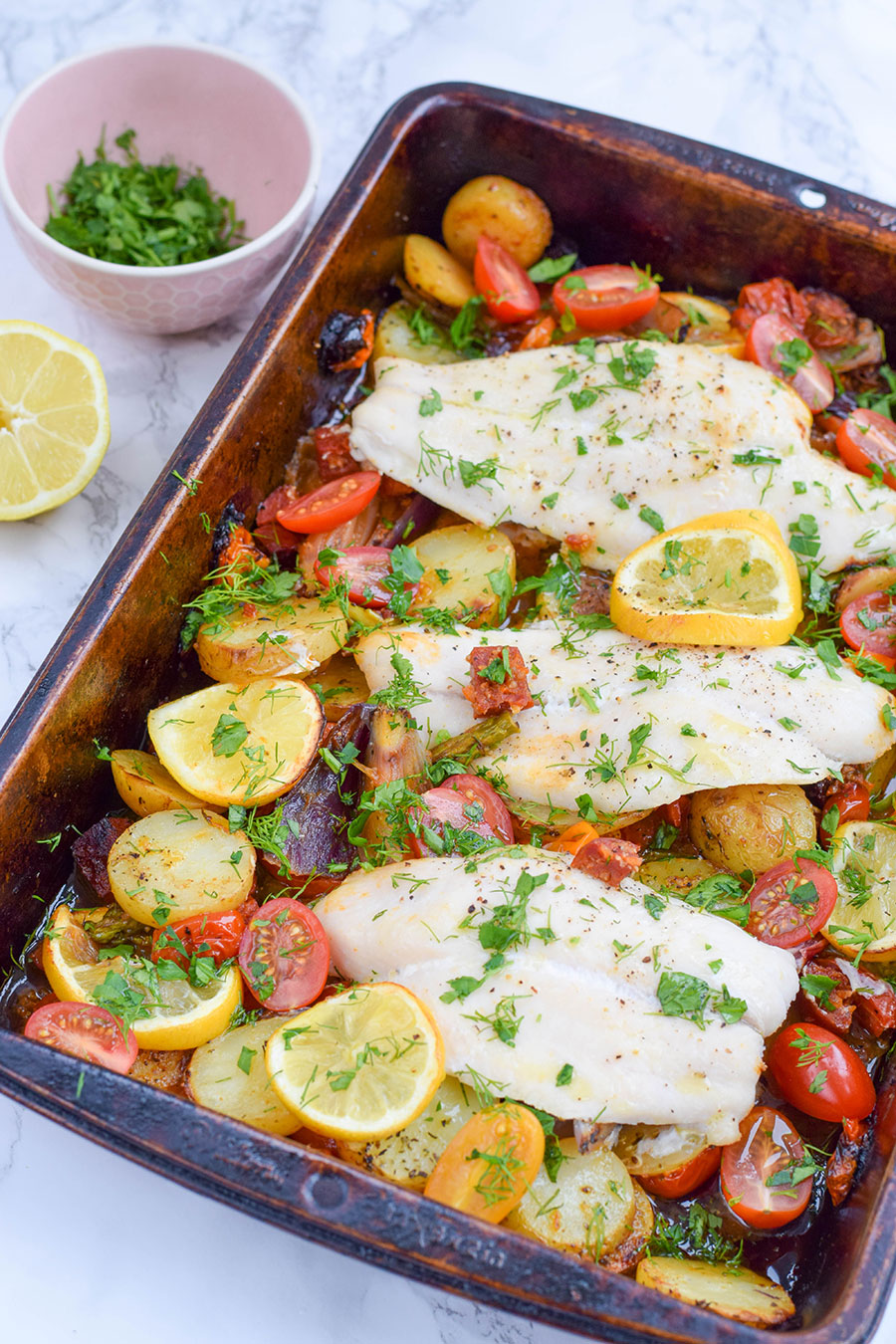 An effortless rainbow vegetable and fish tray bake made with simple ingredients that makes the perfect mid-week family meal.